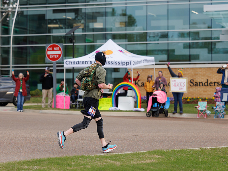 University of Mississippi employees, Children's of Mississippi patients and their families cheered on runners as they passed by the Kathy and Joe Sanderson Tower.